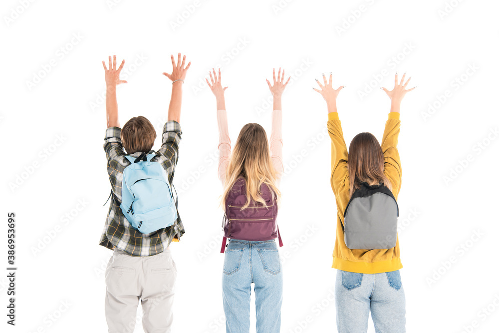 Back view of teenagers with backpacks and raised hands isolated on white Back view of teenagers with backpacks and raised hands isolated on white