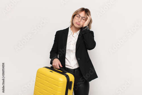 Obraz na płótnie young blonde woman feeling bored, frustrated and sleepy after a tiresome, dull a