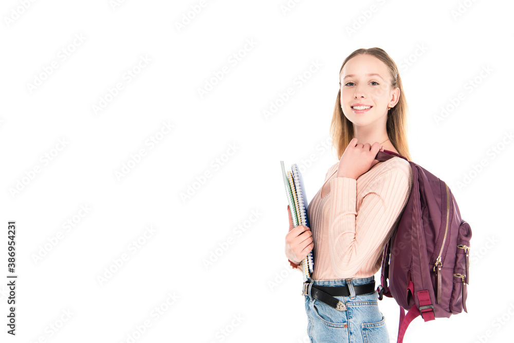 Smiling teenager with notebooks and backpack isolated on white
