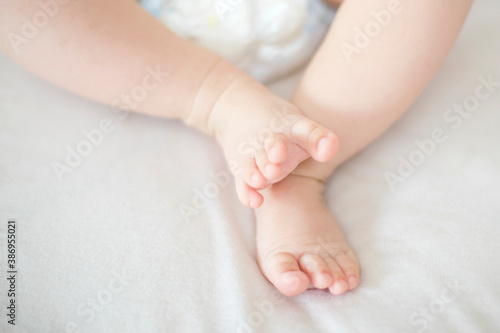 Small baby girl feet on the bed