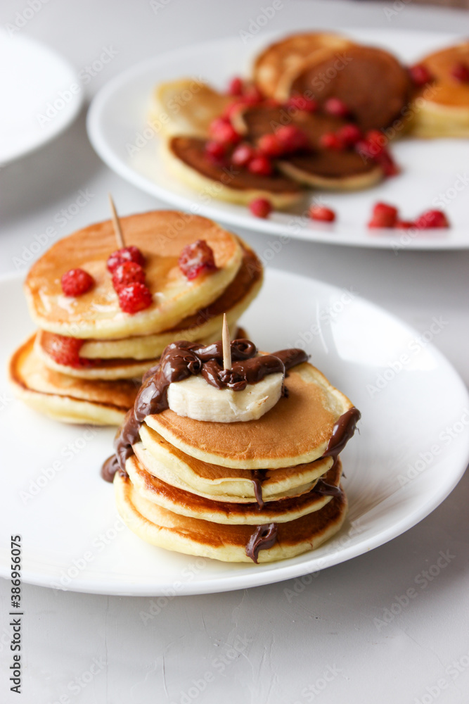 Mini pancakes with fruit drizzled with chocolate and honey
