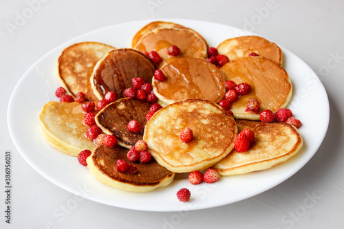 Mini pancakes with fruit drizzled with chocolate and honey