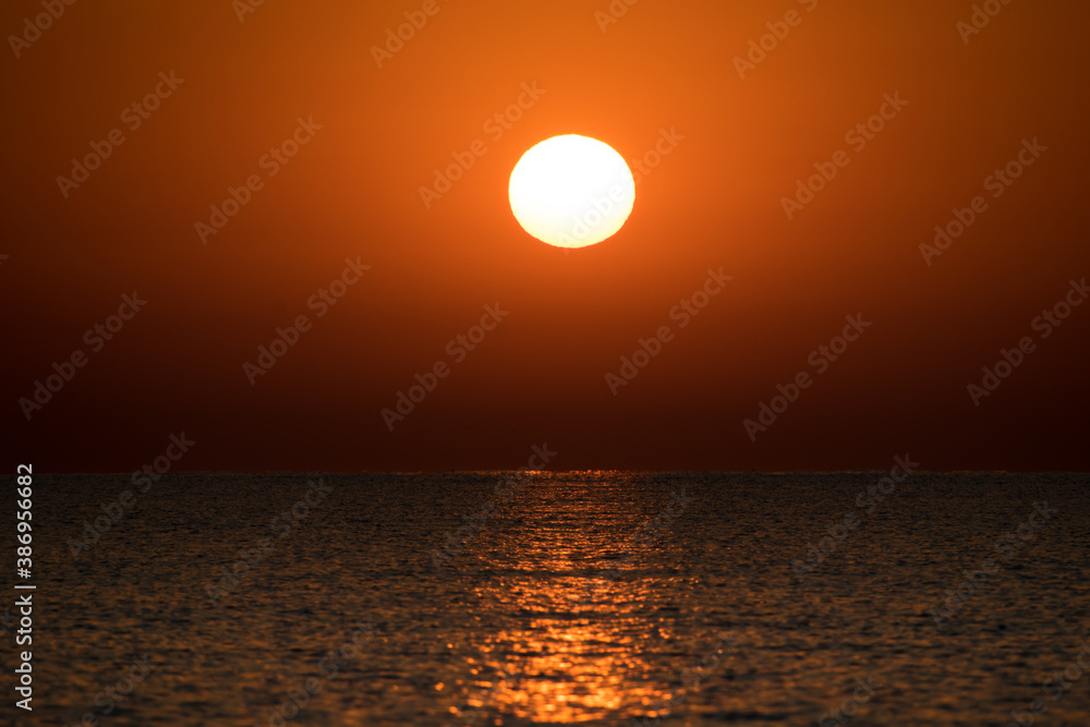 Beautiful vibrant sunrise by the sea. Concept- vacation at the sea
