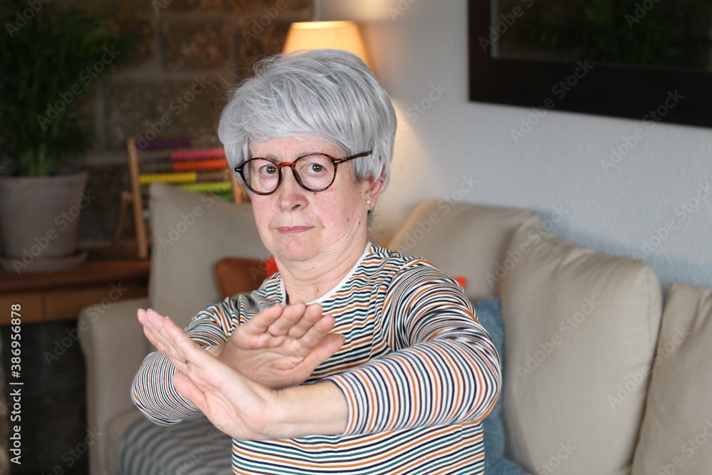 Funny senior woman doing karate position Funny senior woman doing karate position