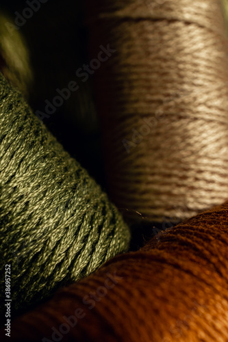 Clousup of different colored spools of yarn photo