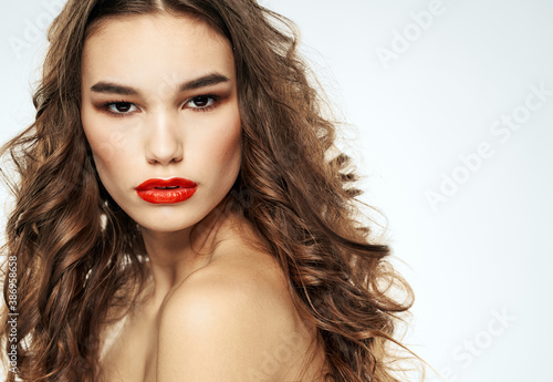 Side view of lady with curly hair red lips