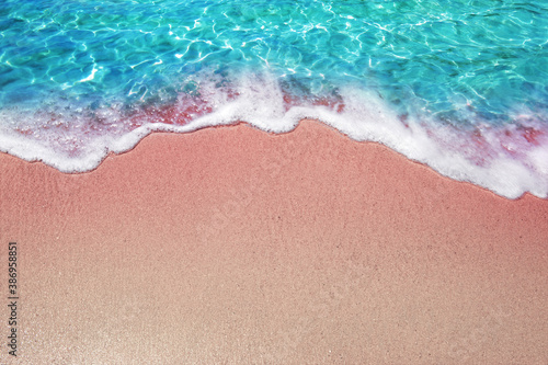 Beautiful Soft waves with form on sea veach of blue ocean water Summer day and pink sandy beach background concept