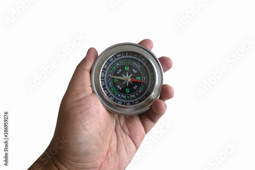 A hand holding a compass isolated on a white background.