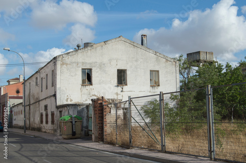 exterior view of an old abandoned warehouse on a street.