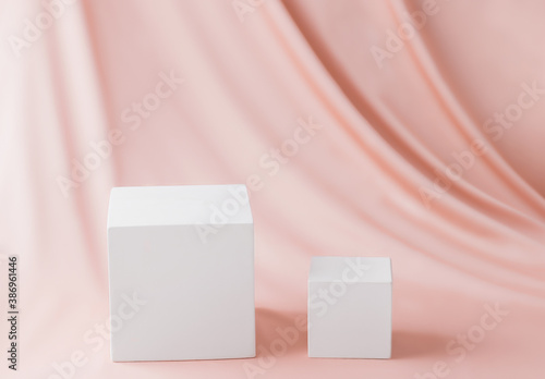 Pedestal platform cube white on a pink silk background
