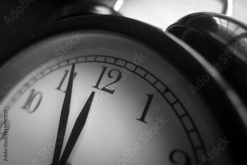 Selective focus of alarm clock in black and white.