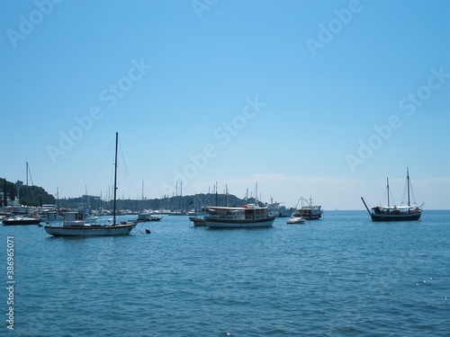 sailboats at the coast or bay of Croatia, with blue sky. Template for design of holiday greetings, decoration packaging, postcard, poster
