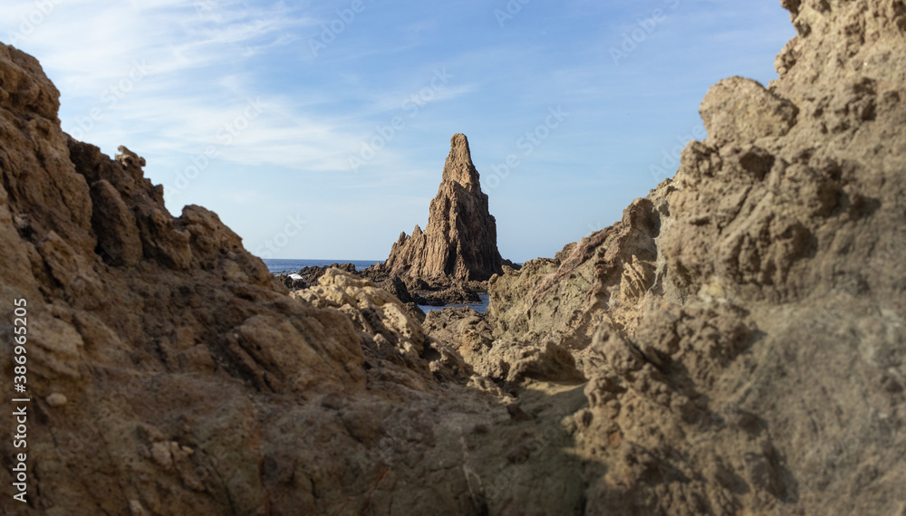 Beautiful pebble beach in the sirens reef with large rocks in the Mediterranean Sea, in Cabo de Gata, in Spain.