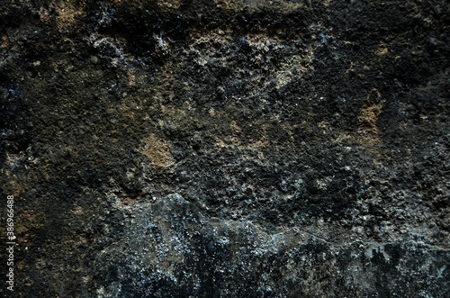 Abstract texture of dark wall with weathered grainy surface