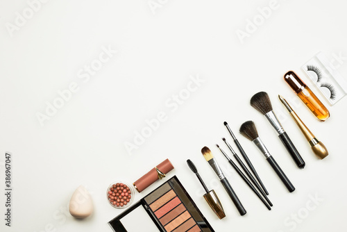 Fashion makeup cosmetic accessories on white background. Top view. Luxury make-up kit