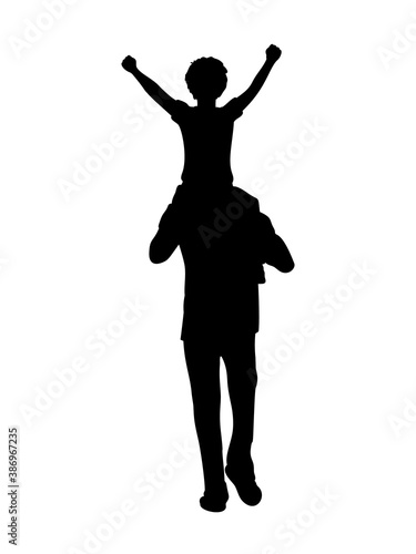 Silhouette father walking with his son on his shoulders from back