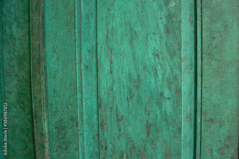 Background old wooden surface painted with peeling green paint