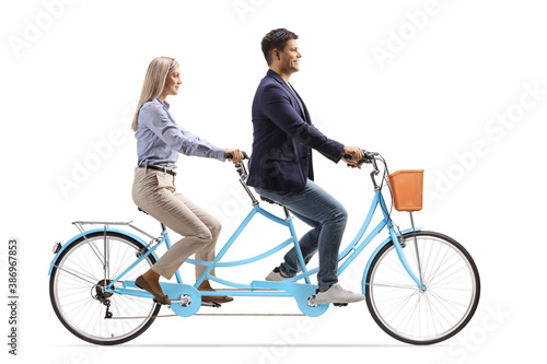 Man and woman riding a tandem bicycle together photo