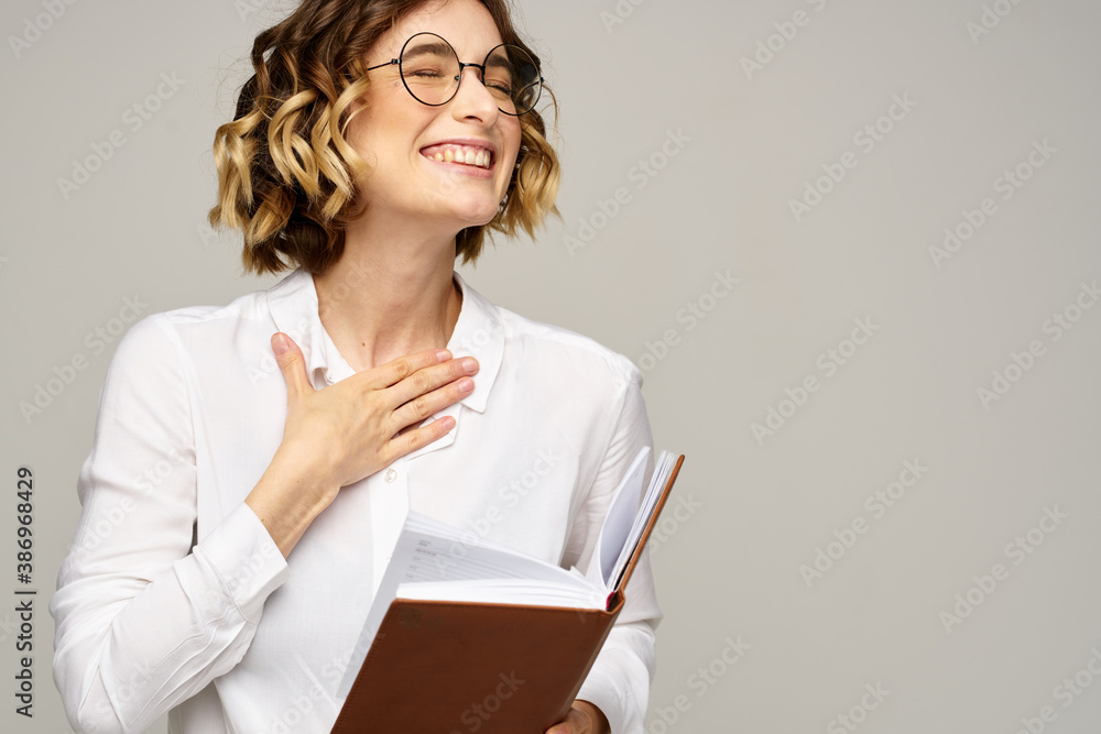 woman with notepad in hands business work beige background glasses hairstyle woman with notepad in hands business work beige background glasses hairstyle