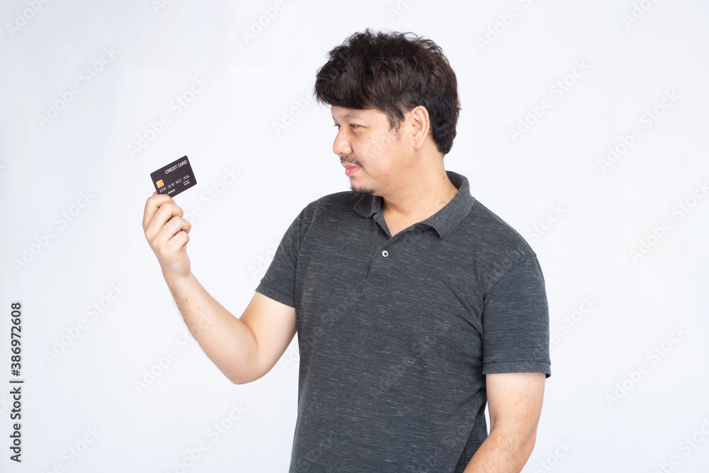 Asian man holding and looking credit card isolated on white background, credit card concept Asian man holding and looking credit card isolated on white background, credit card concept