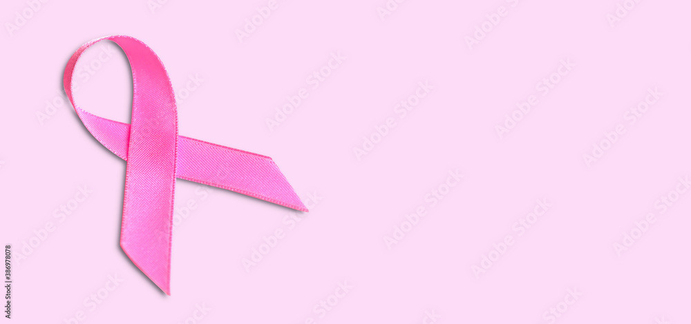 pink ribbon breast cancer on pink background. with copy space.
