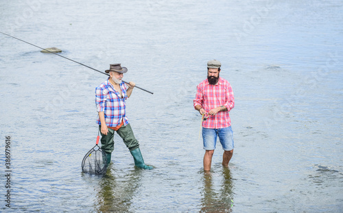 best friends. father and son fishing. Poaching. Camping on the shore of lake. concept of a rural getaway. hobby. wild nature. happy fisherman with fishing rod and net. Big game fishing. friendship