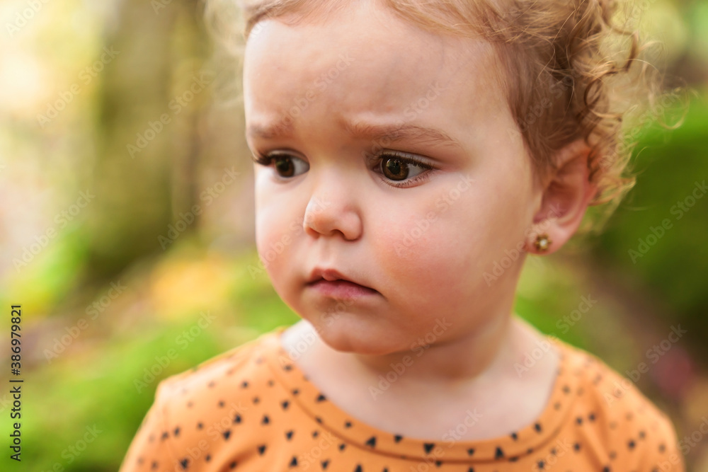 Cute and fashion child girl in autumn park look sad Cute and fashion child girl in autumn park look sad