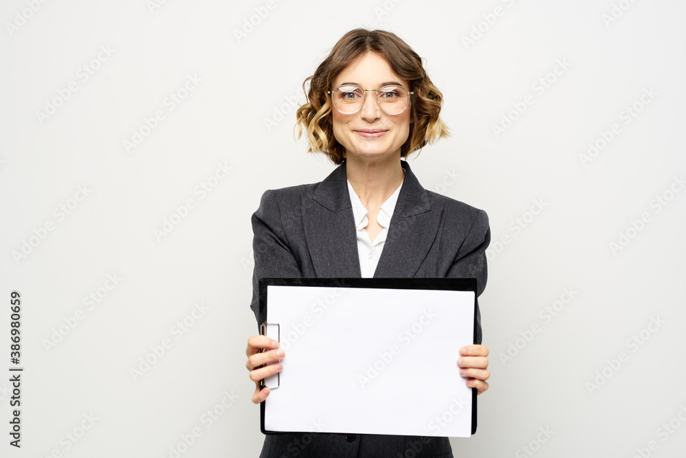 Business woman with a folder of documents on a light background cropped view and shirt suit Business woman with a folder of documents on a light background cropped view and shirt suit