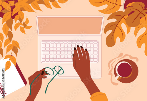 Woman using laptop. Top view. Autumn season. Working from home and cafe, remote job. Online shopping. 