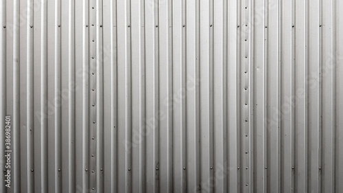 Corrugated sheet vertical metal texture background with rivets photo