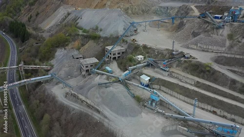 Bologa,Cluj/Romania-June 02.2019-Aerial view over the only granite quarry in Transylvania located in Bologa village. Industrial mining equipment - stone transporting equipment  photo