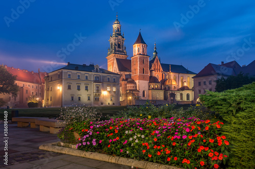 Wawel castle and Wawel cathedral seen from colorful garden in the night, Krakow, Poland