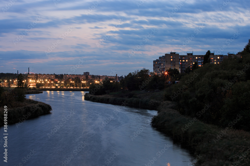 River on the outskirts of the city in Eastern Europe in the evening