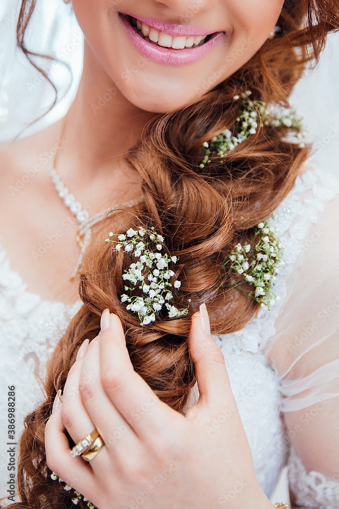 Beautiful young bride in whit wedding dress and flowers