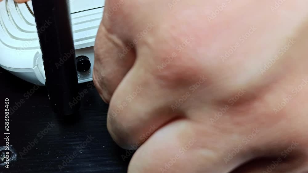 Man disconnects the ethernet network cable from the router. Wi Fi connection. Man disconnects the ethernet network cable from the router. Wi Fi connection.