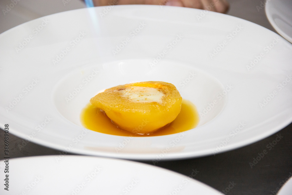 Preparing dessert of pear brulee with dolce gorgonzola cheese