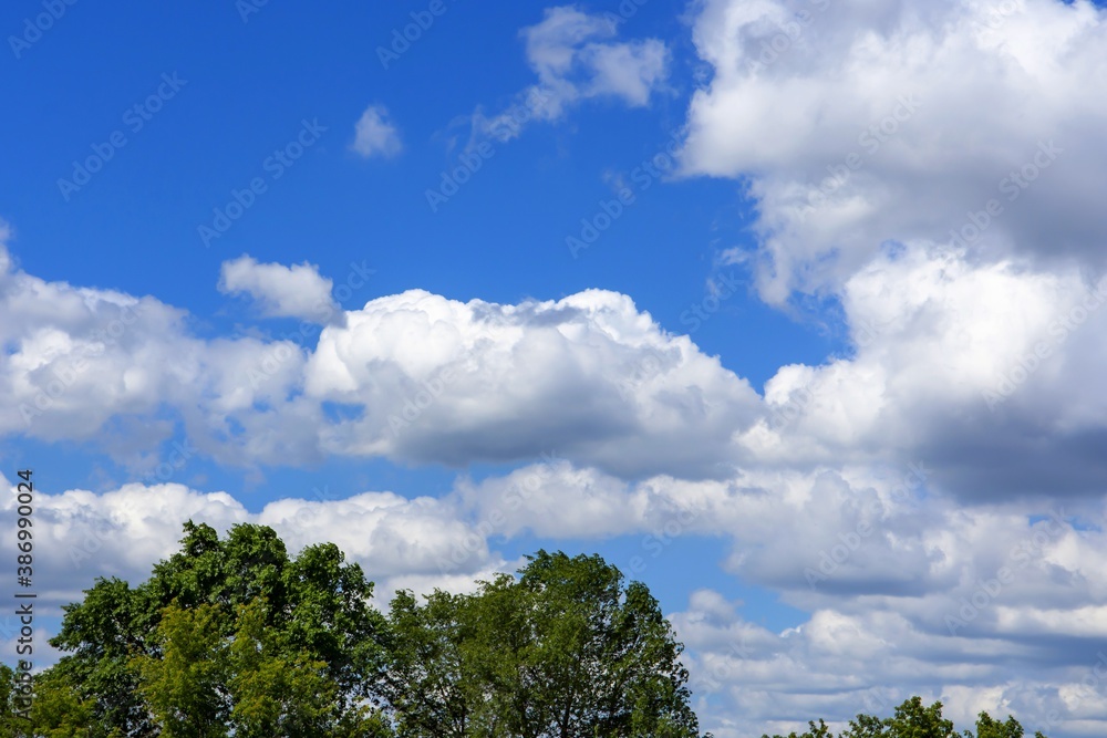 white cumulus clouds against a bright blue sky white cumulus clouds against a bright blue sky