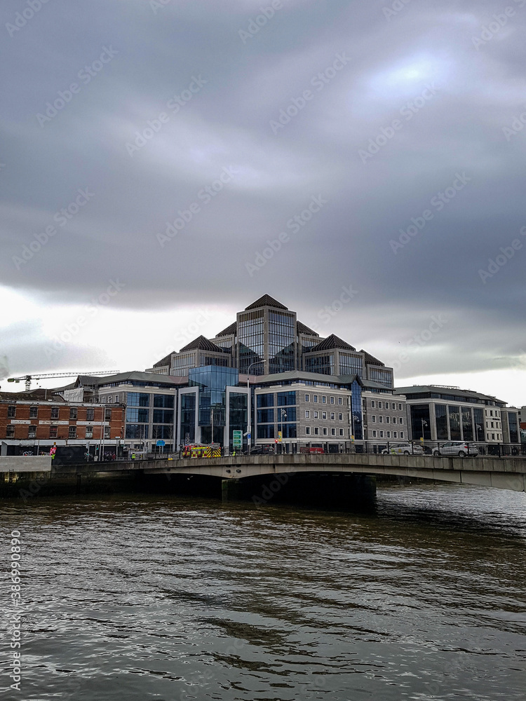Iluminati building next to the river and bridge in Dublin, Ireland 