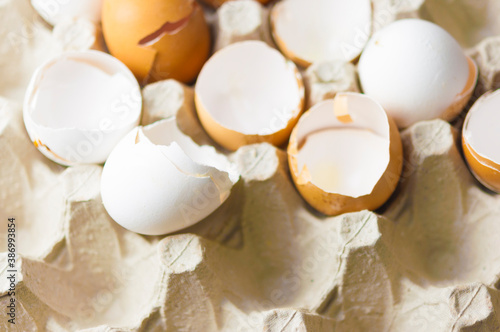 many shell egg scattered in a cardboard package made of recycled waste paper.