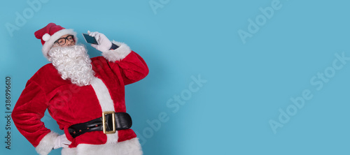 santa claus isolated on background with mobile phone