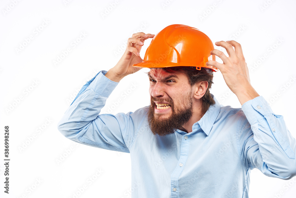 Angry man in orange hard hat industry work dissatisfaction cropped view Angry man in orange hard hat industry work dissatisfaction cropped view