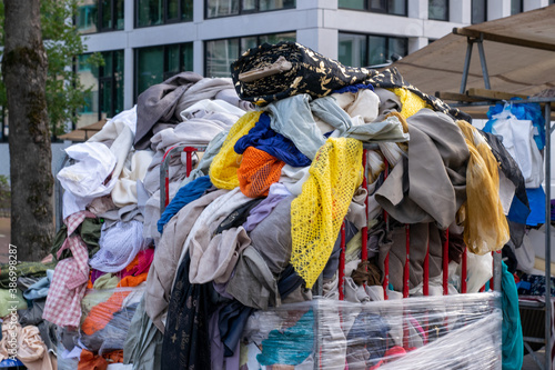 Pile of old clothes dumped in a container