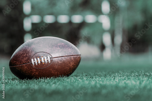 Foto American football, rugby ball on green grass field background