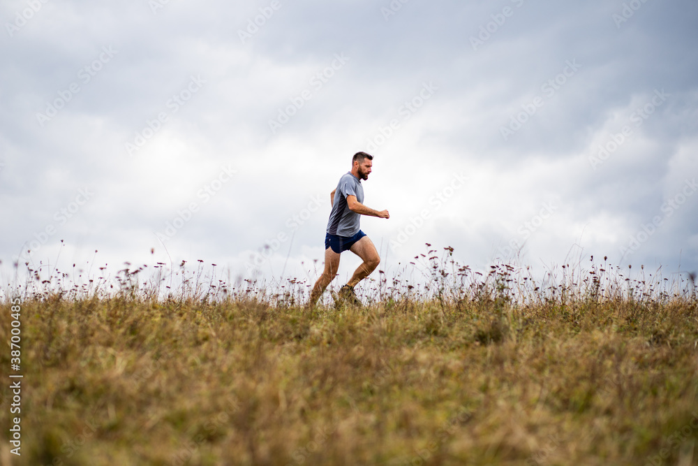 handsome trail runner running in nature handsome trail runner running in nature