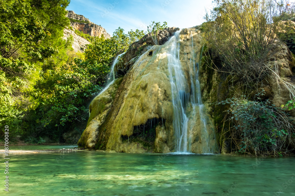 Fototapeta premium A large beautiful waterfall in a forest.