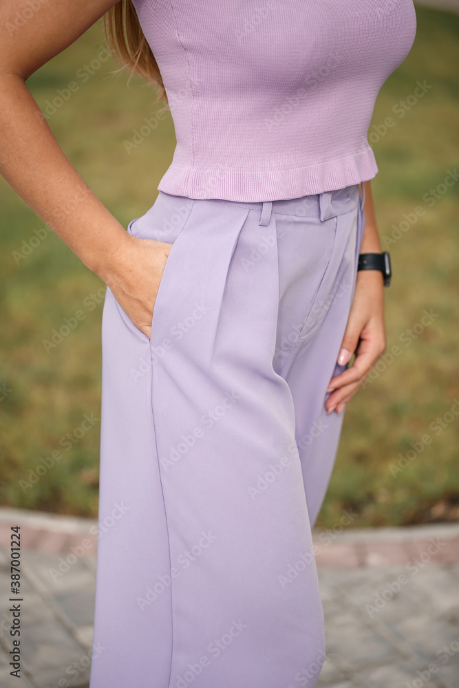 Young beautiful girl in lavender palazzo pants and in a summer crop top