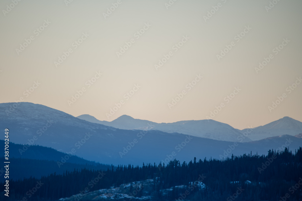 Pastel mountainscape, mountain landscape with hazy views and scenic Yukon, northern Canada views. Taken in October, just as the first snow has fallen. 