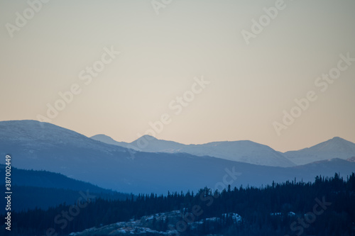 Pastel mountainscape, mountain landscape with hazy views and scenic Yukon, northern Canada views. Taken in October, just as the first snow has fallen. 