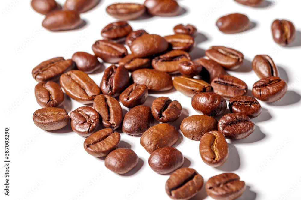 Heap of fresh roasted coffee beans isolated on white background as package design elements Heap of fresh roasted coffee beans isolated on white background as package design elements