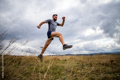 handsome trail runner running in nature